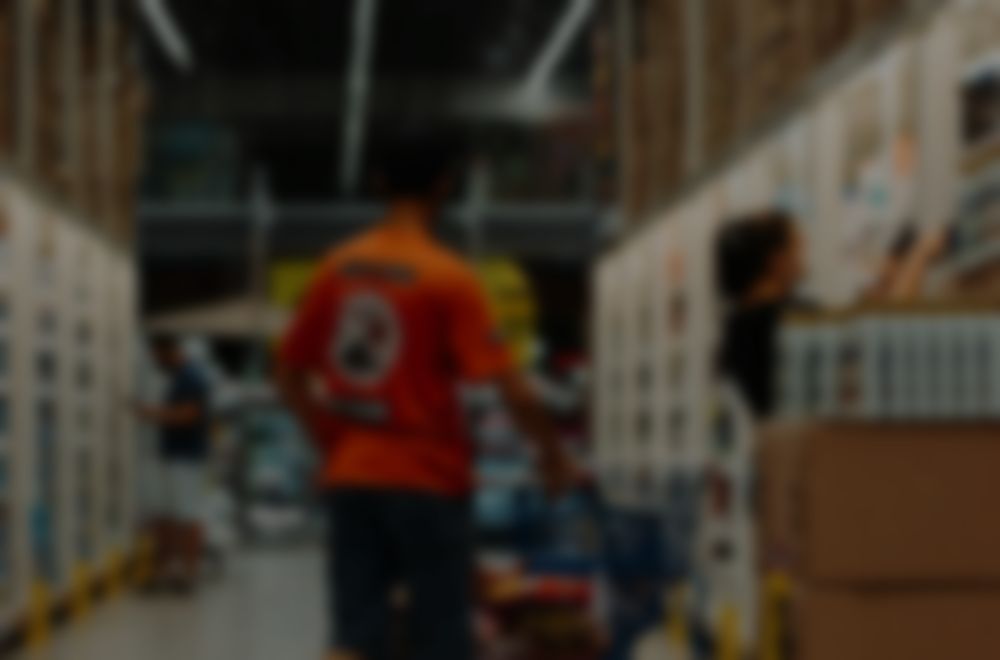 Store floor, softly blurred, behind an incoming StorePulse alert notification